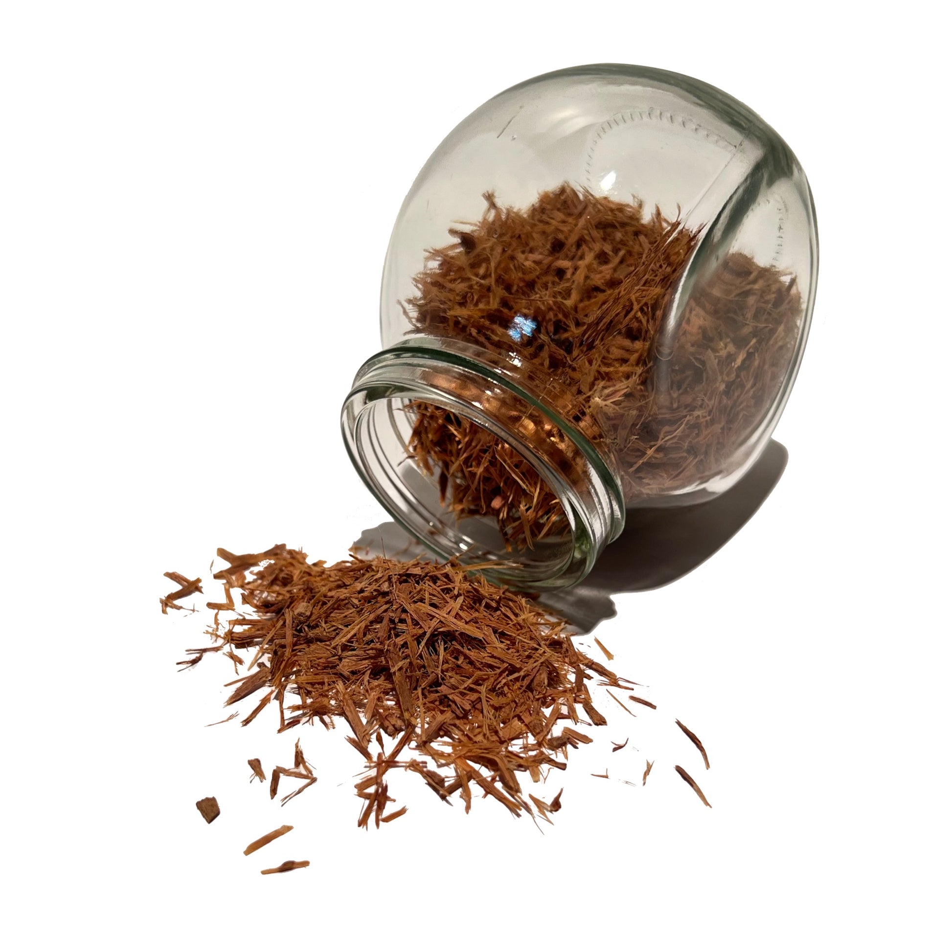 Cat’s claw bark chips spilling from a glass spice jar
