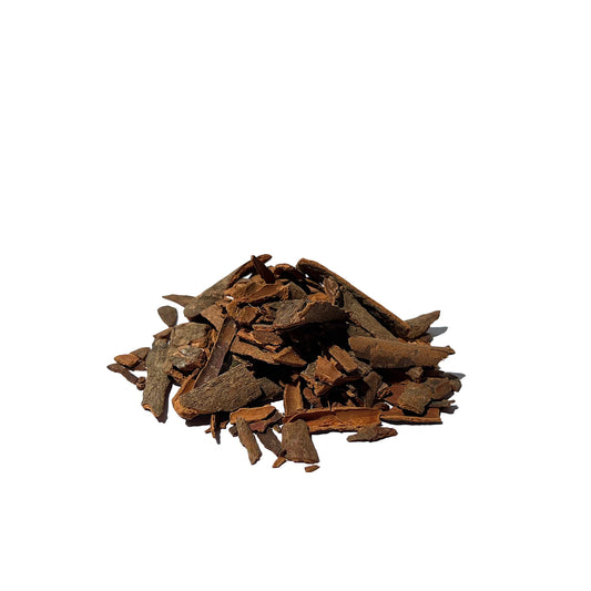 Reddish-brown cinnamon bark chips on a white background