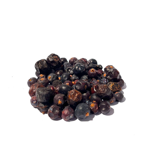 Dimpled, bluish-black and maroon juniper berries in a pile