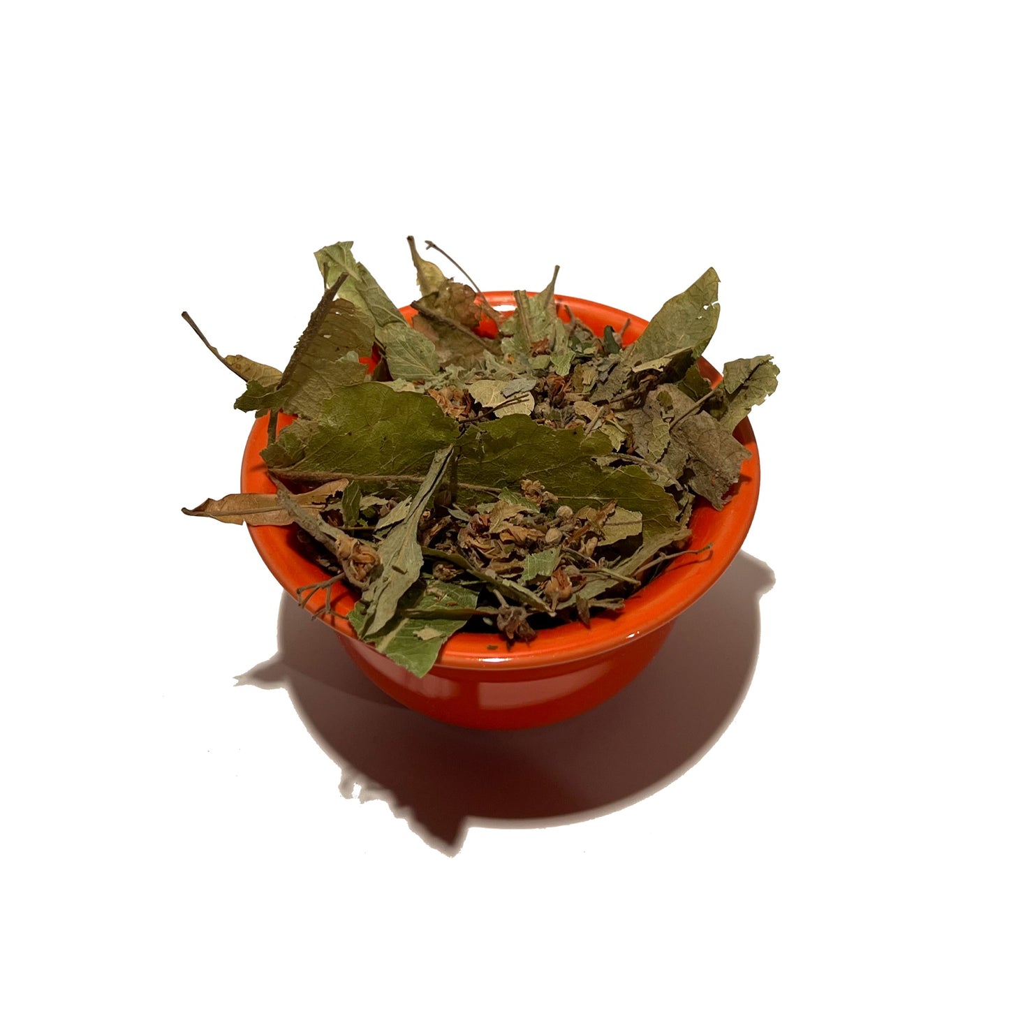Orange bowl overflowing with dried linden leaf and flowers
