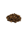 Dried cuts of angelica root piled on a white background