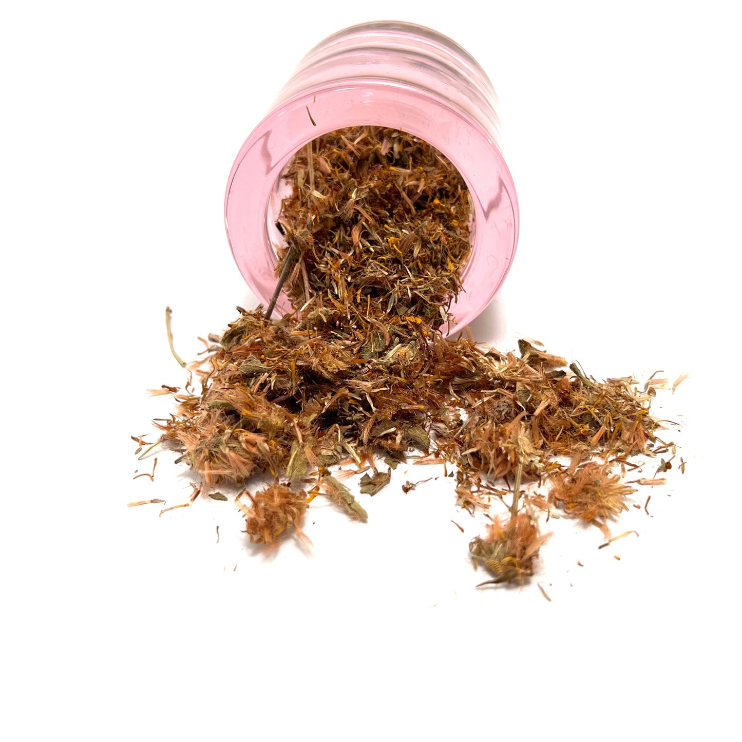 Small, round pink jar on its side, spilling dried flower parts