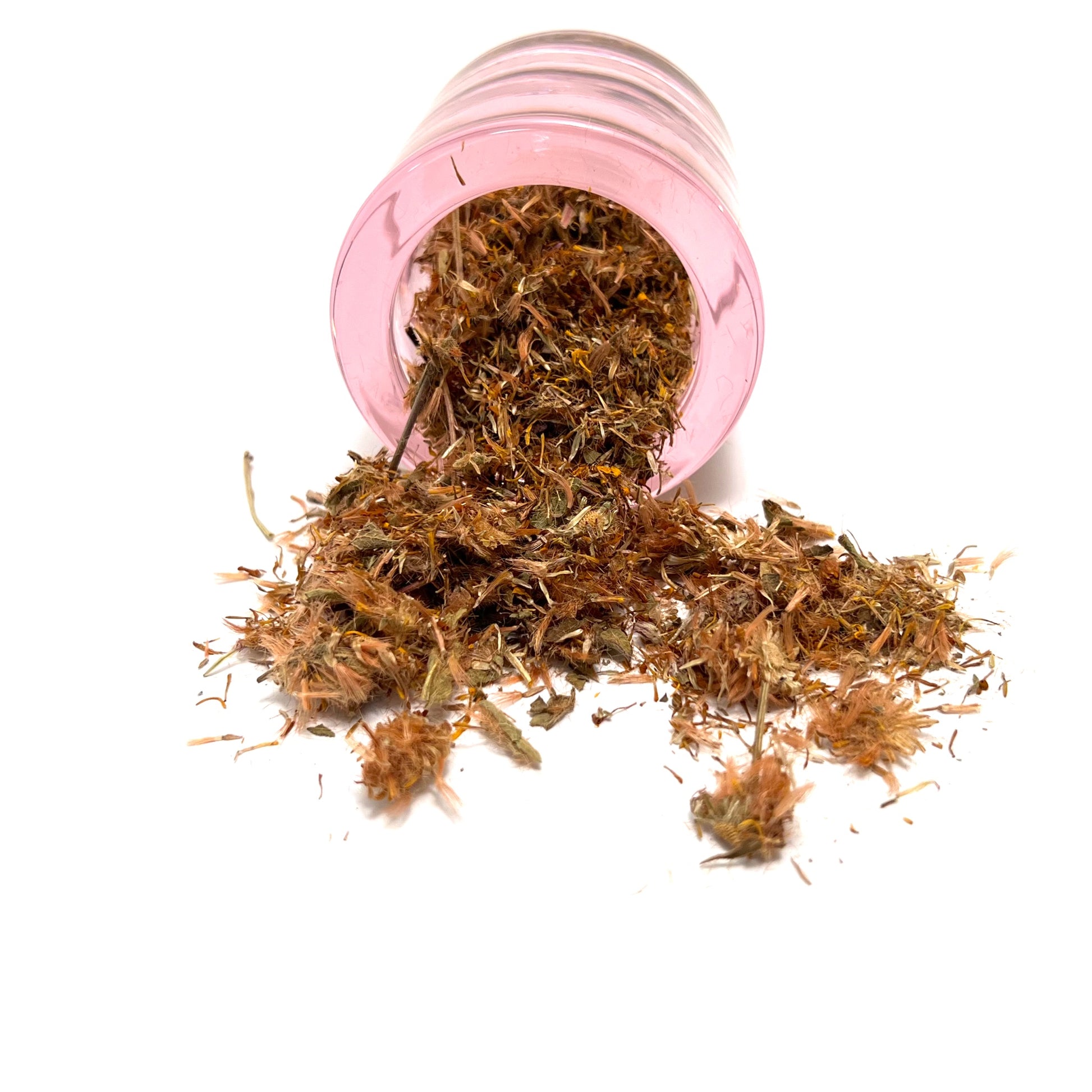 Small, round pink jar on its side, spilling dried flower parts