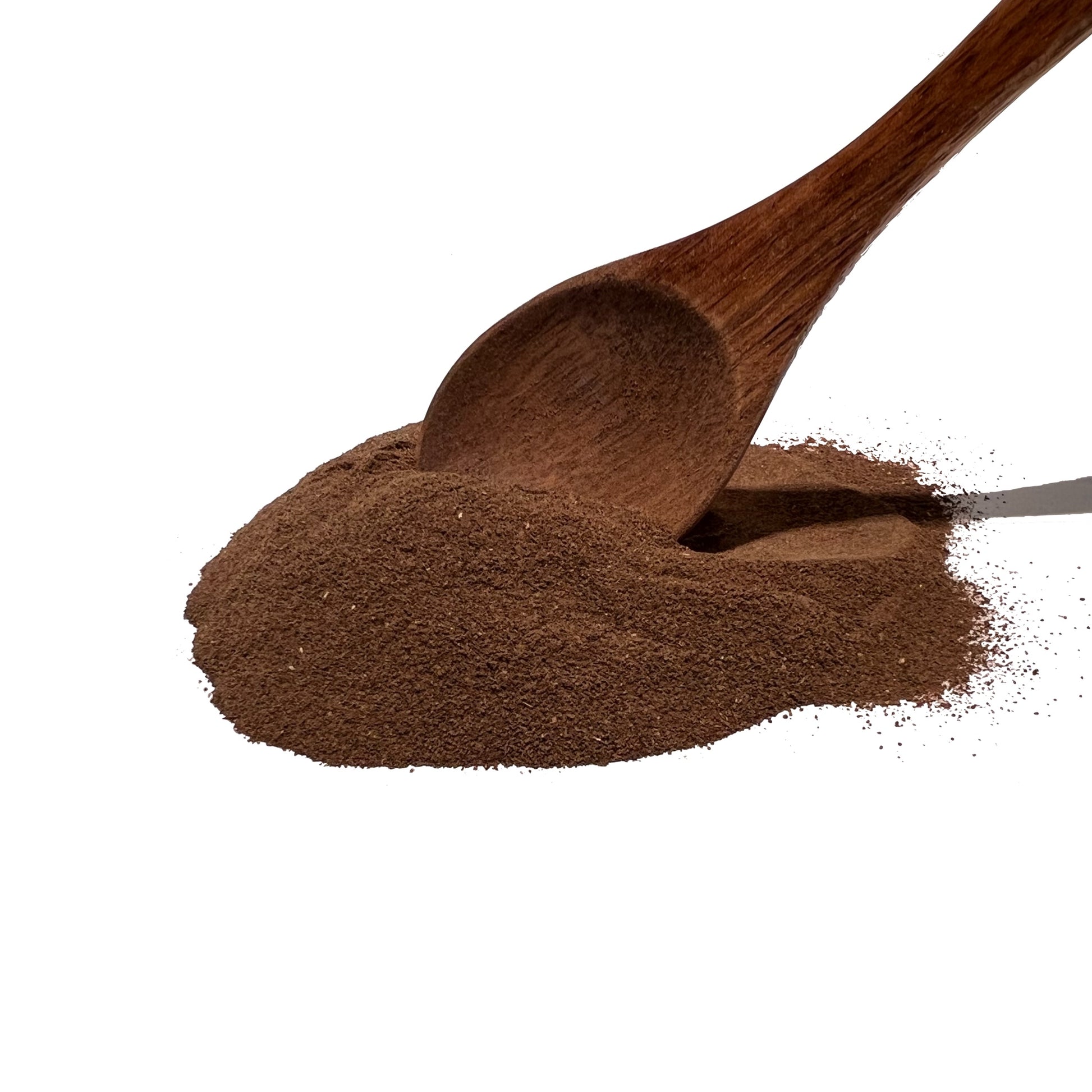 Wooden spoon smoothing a pile of dark brown powder