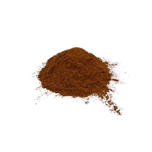 Cassia cinnamon powder piled on a white background
