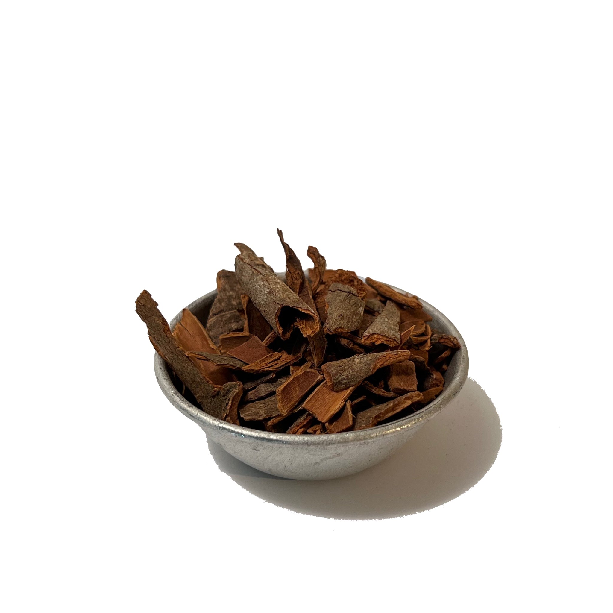 Pieces of cinnamon bark in a small pewter bowl