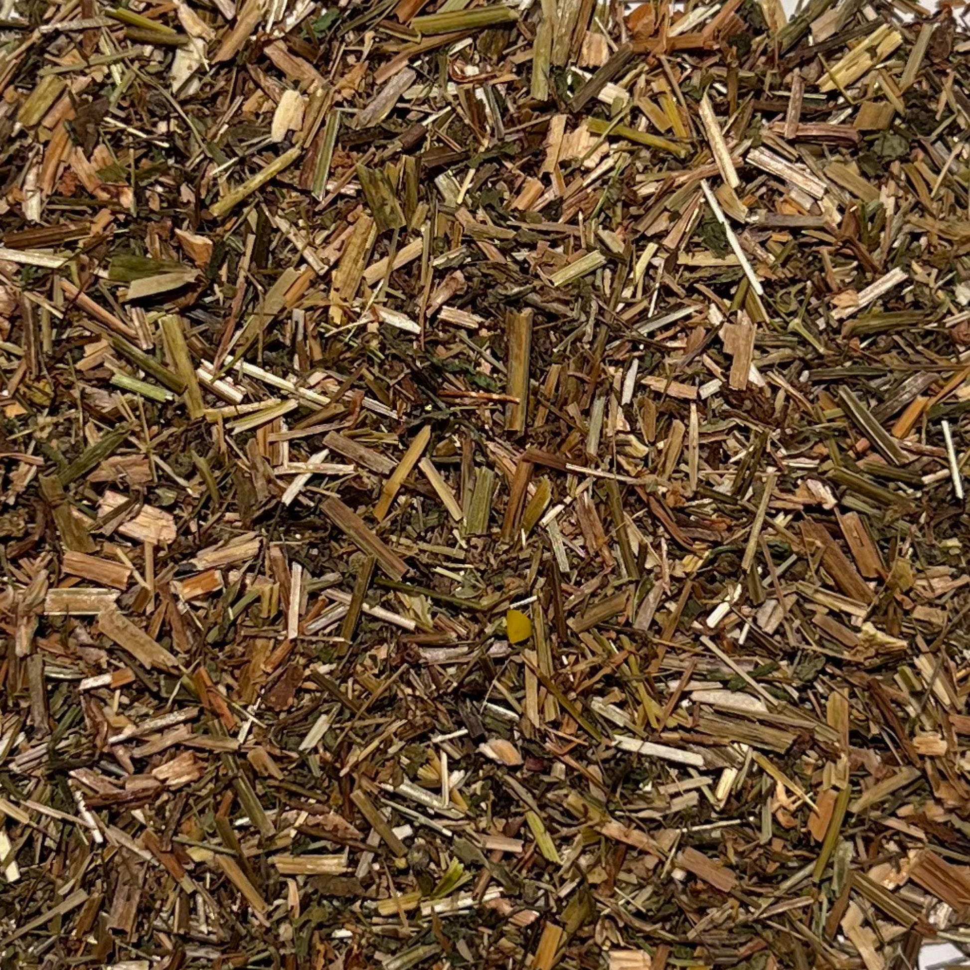 Stems and leaves of dried cleaver herb in brown, yellow and green tones