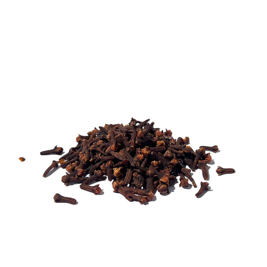 Half a cup of dried whole cloves piled on a white background