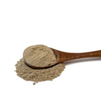 Wooden spoon full of and resting in echinacea root powder