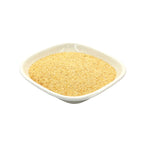 A mound of fine golden-yellow granulated garlic, presented in a small white square dish against a solid white background.