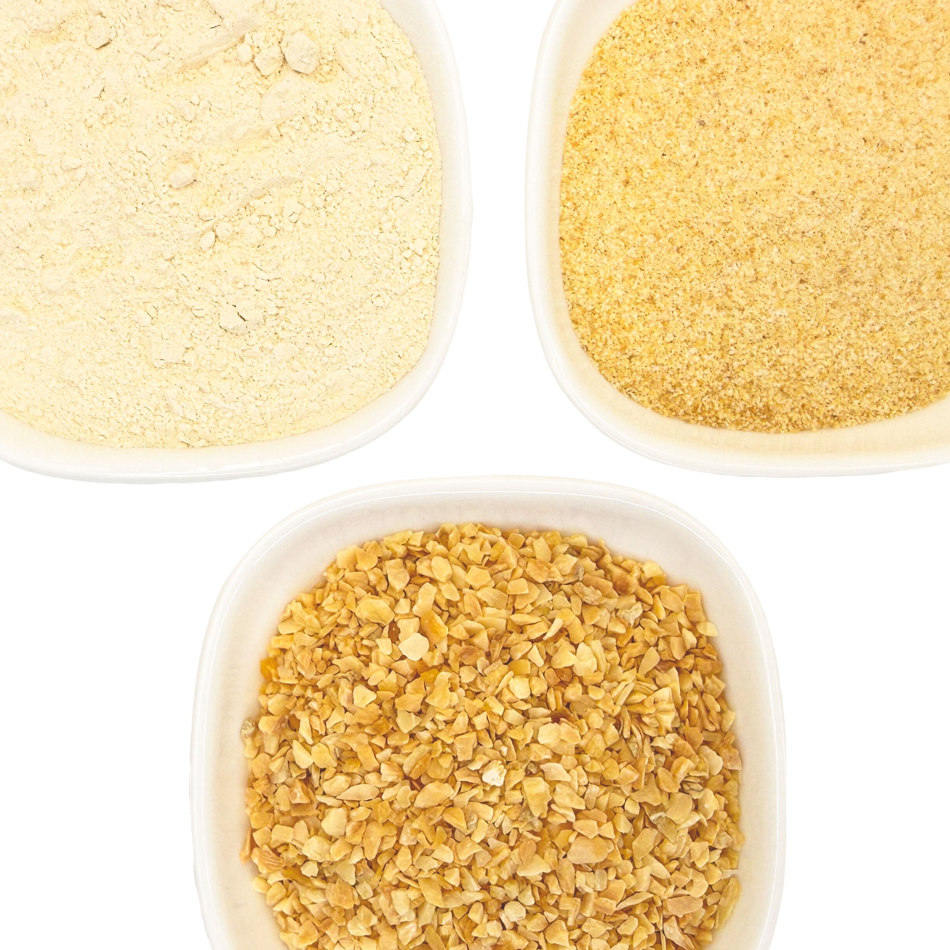 Three white bowls containing different textured garlic - powdered, granulated, and minced - arranged on a white background. 