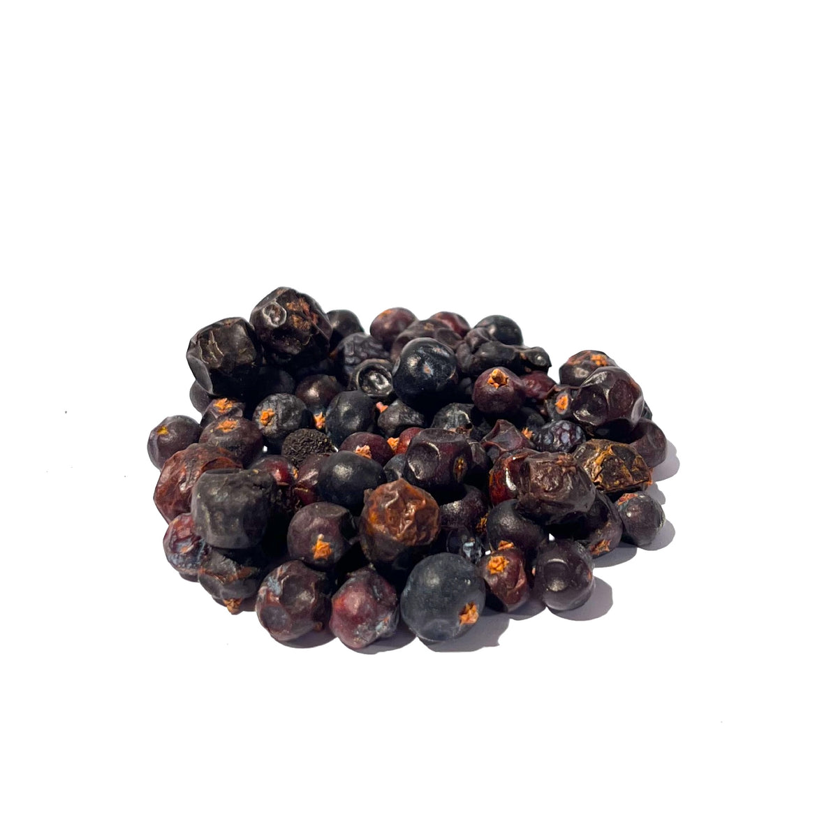 Dimpled, bluish-black and maroon juniper berries in a pile
