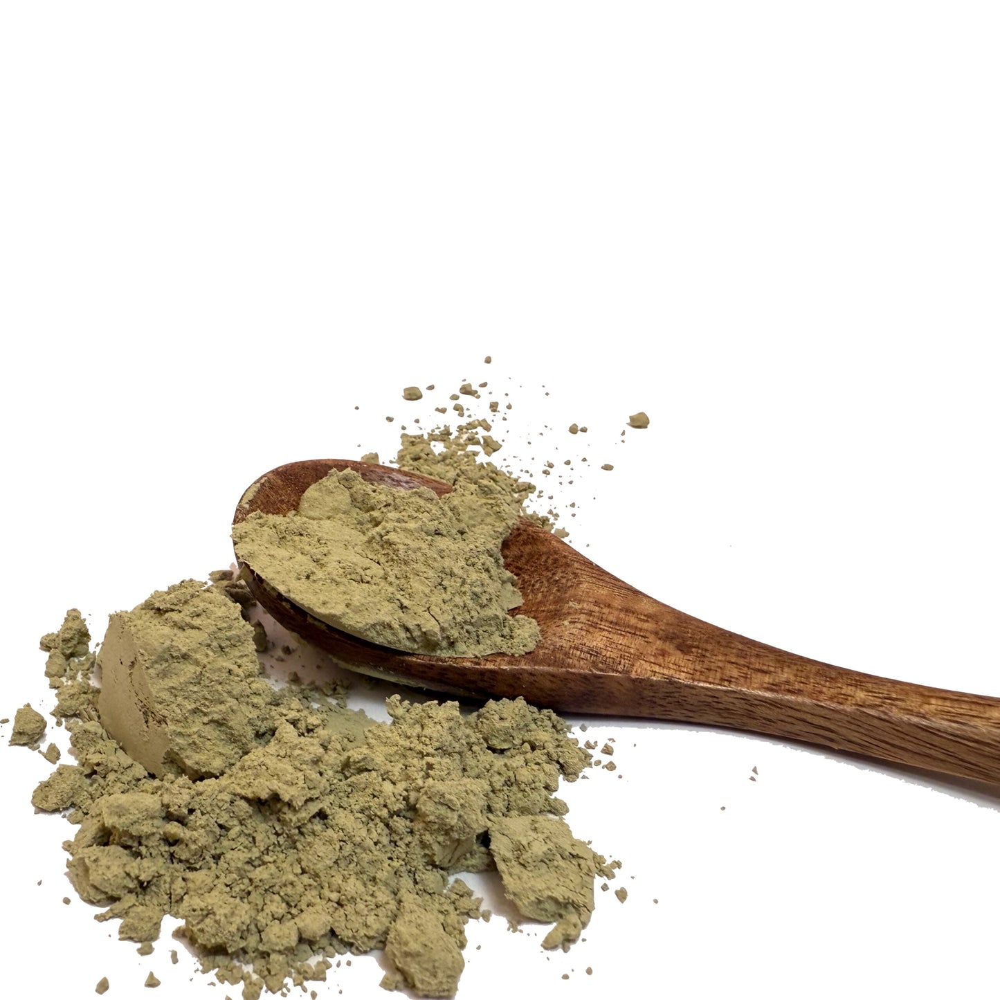 Wooden spoon with green kelp powder spilling on a white background