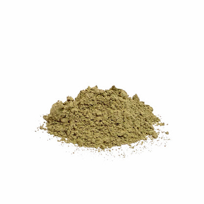 Pile of green kelp powder on a white background
