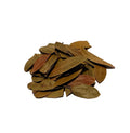 Whole dried uva ursi leaves in olive green tones, piled on a white background