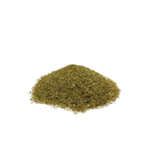 Powdered green herb piled on a white background