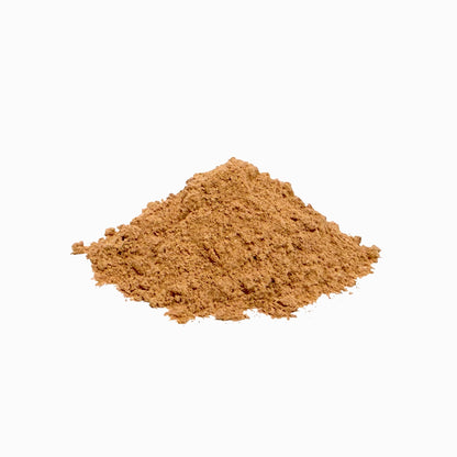 Pile of clumpy, caramel-colored astragalus powder