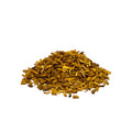Pile of dried yellow barberry bark chips on a white background