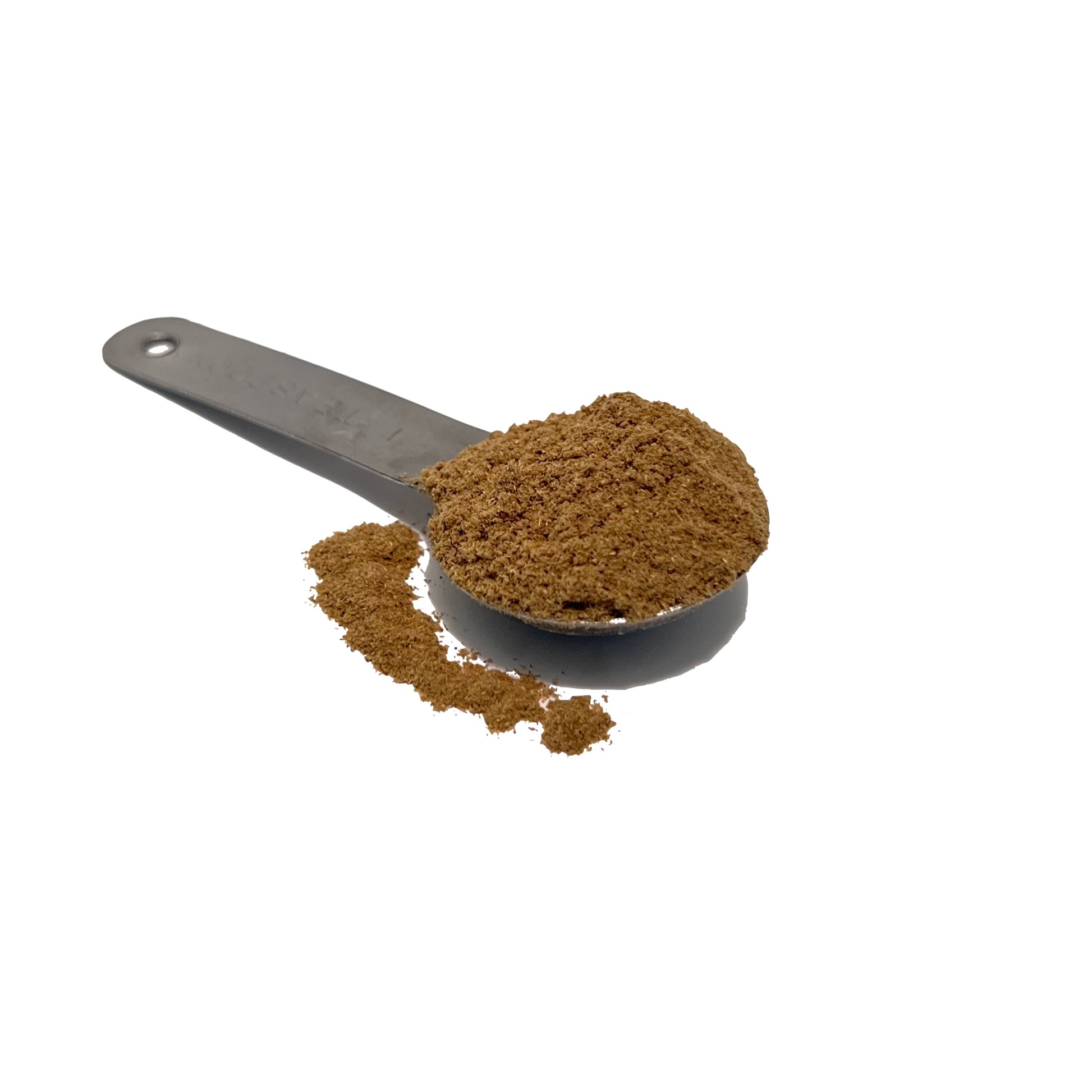 Metal teaspoon overflowing with medium brown chamomile powder.