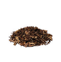 Dried pieces of black Culver’s root piled on a white background