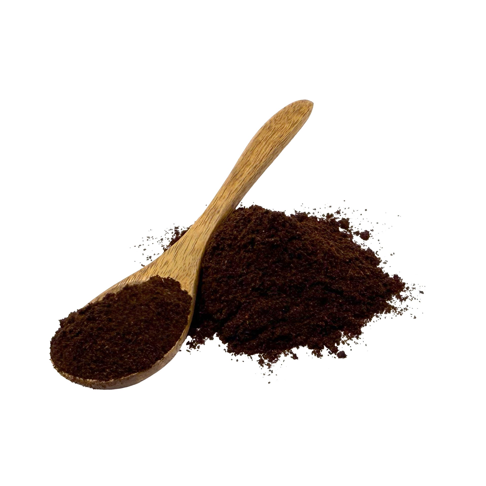 A wooden spoon filled with dark elderberry powder with more of the same piled behind it on a plain white background.