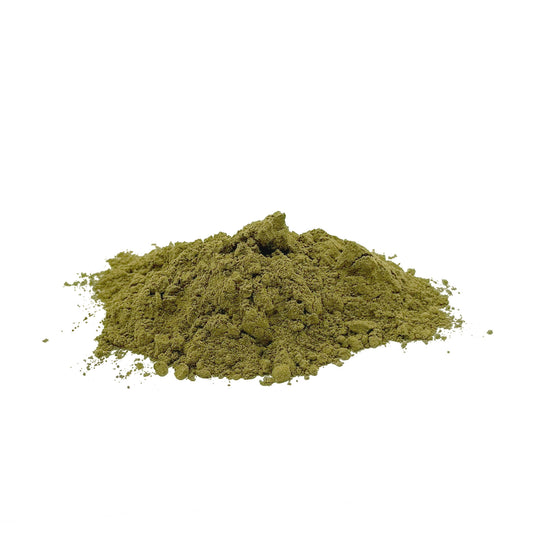 A small mound of fine green herb powder, centered on a plain white background.