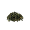 Dried goldenseal leaves and stems piled on a white background
