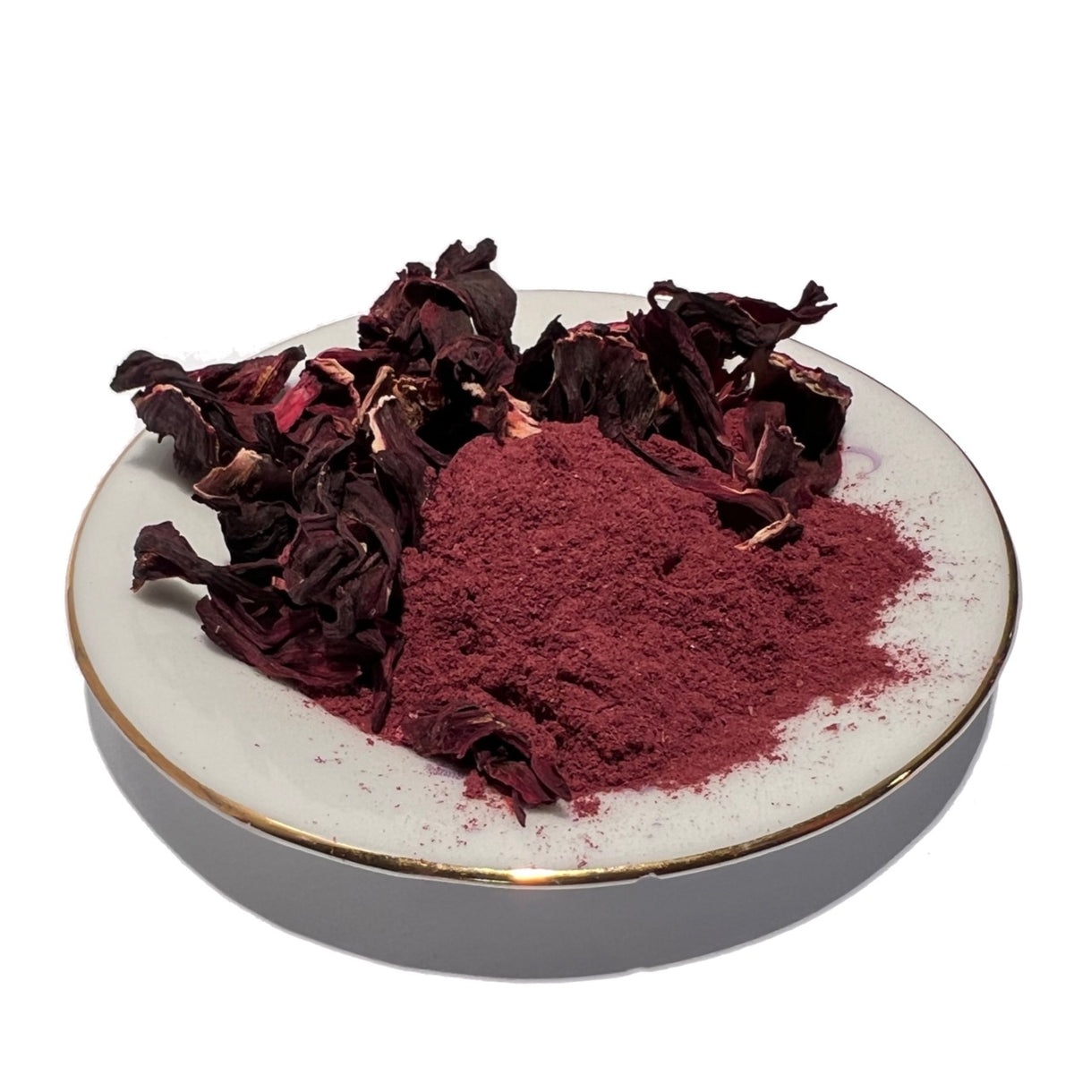 Small gold-rimmed plate with dried hibiscus flowers and powder