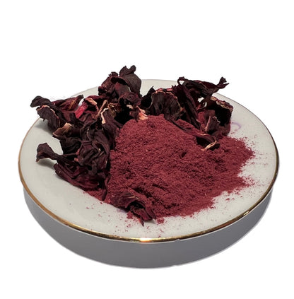 Small gold-rimmed plate with dried hibiscus flowers and powder