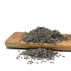 Dried English Lavender spilling off a wood cutting board