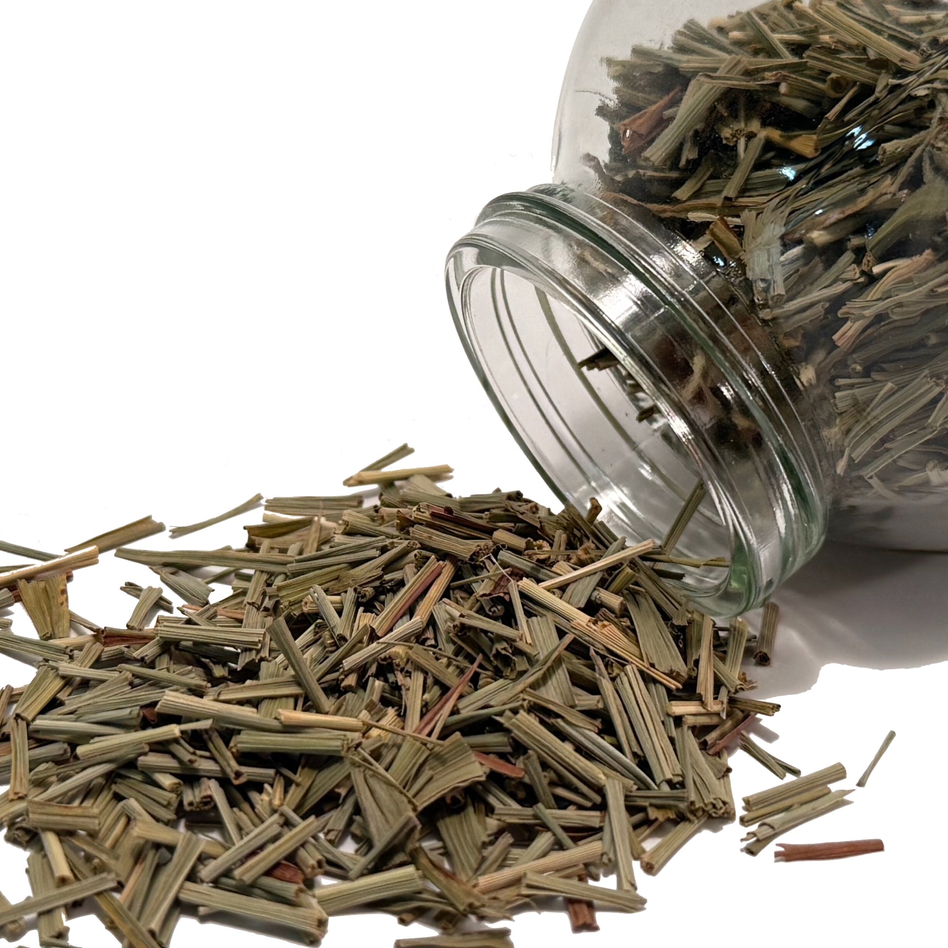Dried lemongrass spilled from a Mason jar on its side
