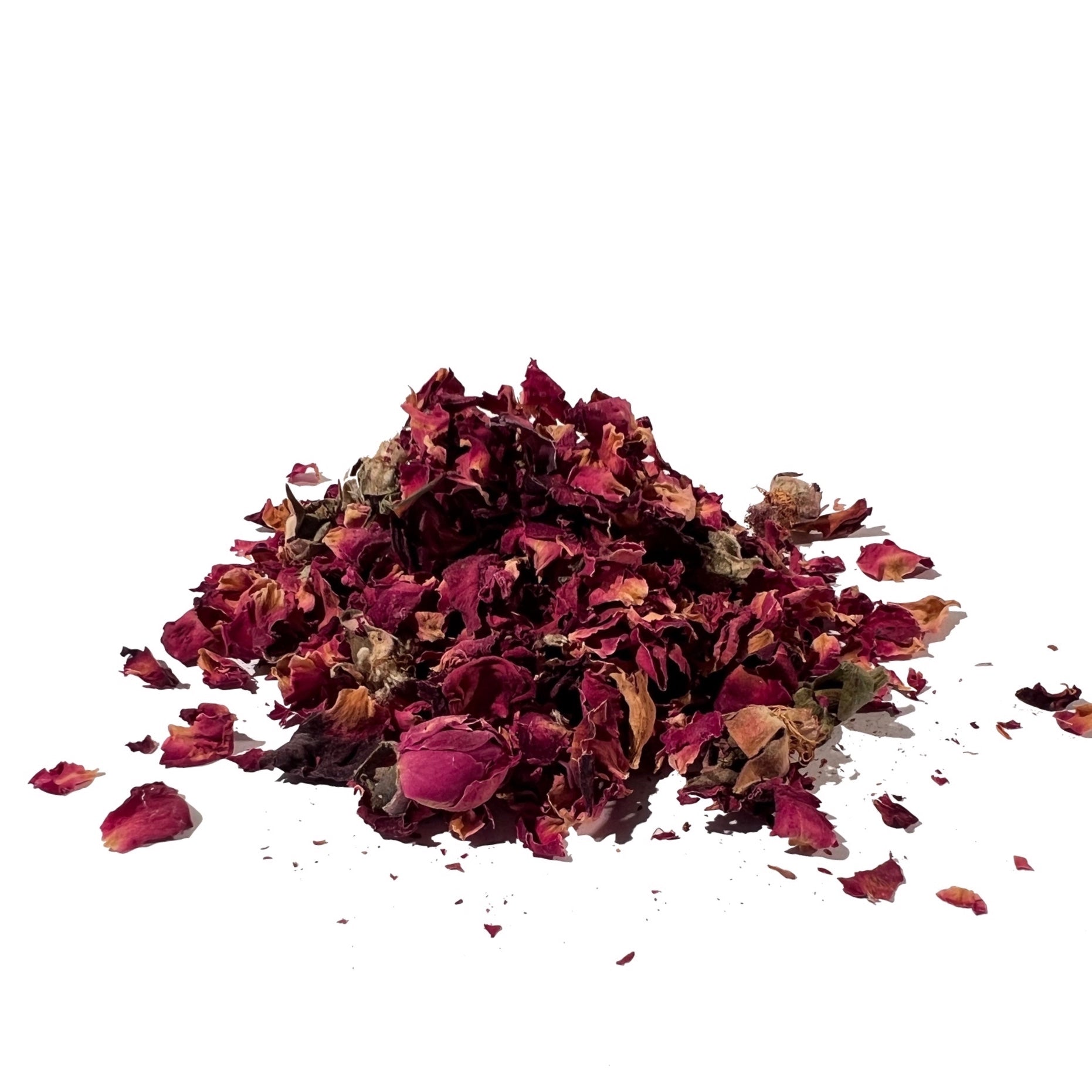 Scattered pile of dried rose buds and loose petals