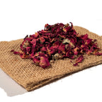 Dried red rose buds and loose petals on folded burlap