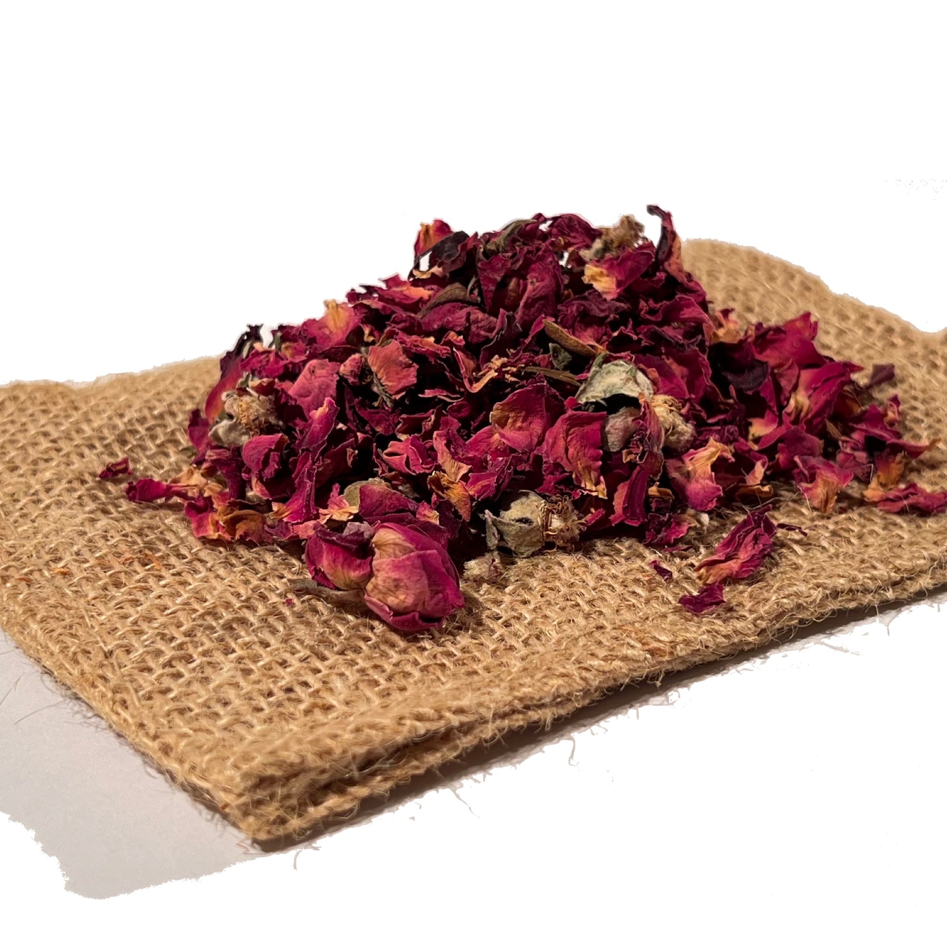Dried red rose buds and loose petals on folded burlap