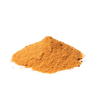 Yellow-orange rose hip powder piled on a white background