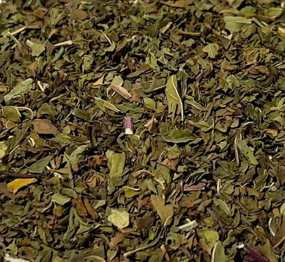 Detail of dark green and olive-tone rubbed spearmint leaves
