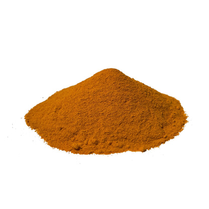 Golden-orange turmeric powder piled on a white background