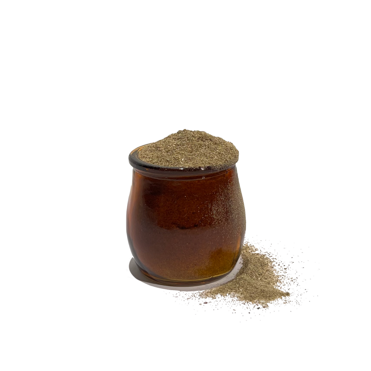 Vintage brown glass jar overflowing with wild lettuce powder
